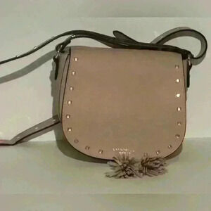 A Victoria’s Secret light pink crossbody bag w/ tassels.